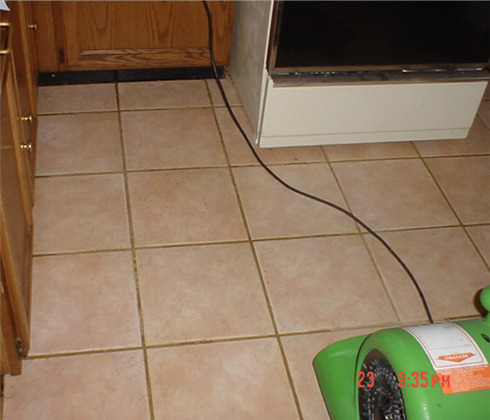 Tile floor in kitchen with green drying equipment set up and running.