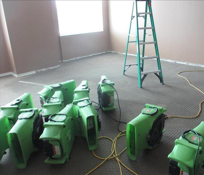 Air movers in an empty room with no flooring