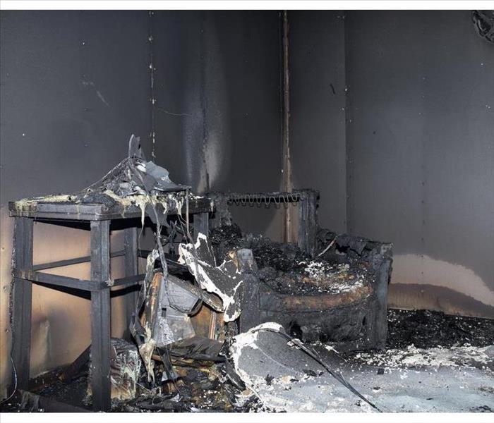 chair and furniture in room after burned by fire in burn scene of arson investigation course